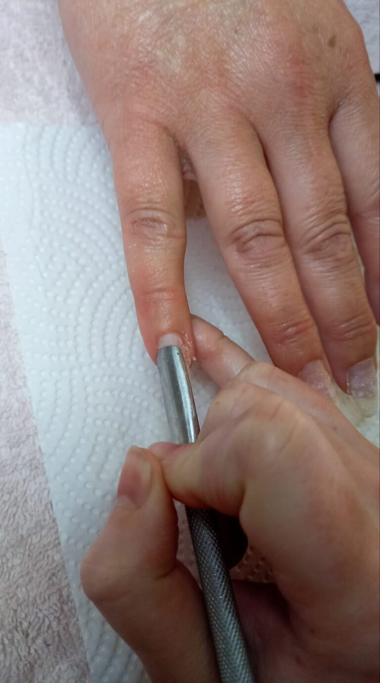 cuticles being pushed back using cuticle pusher